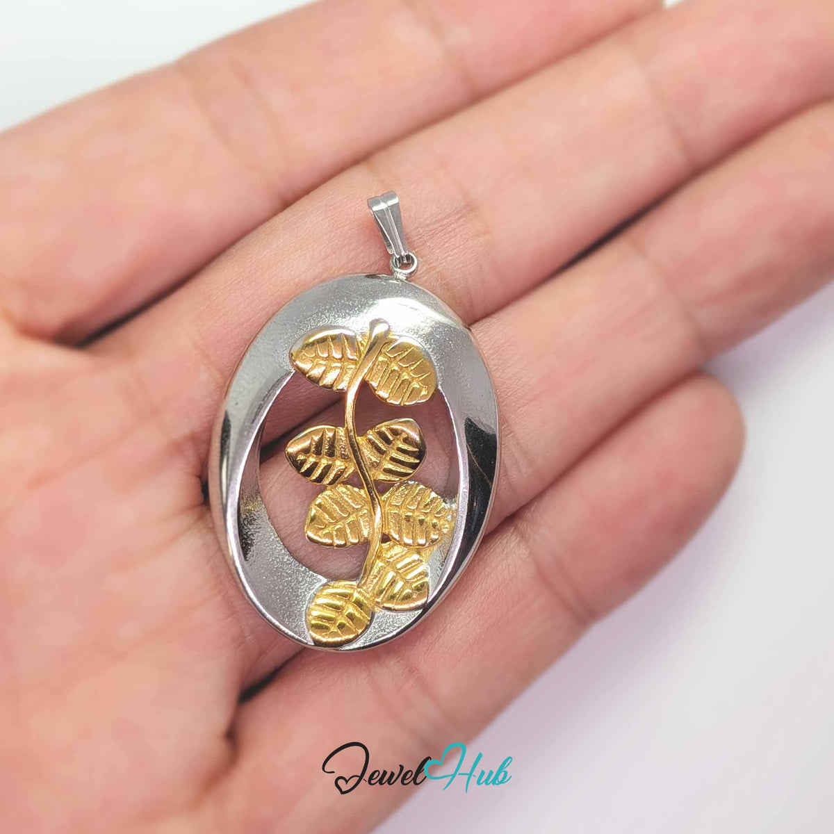 Oval Branch pendant in DuoTone stainless steel - held in the hand to show size - JewelHub