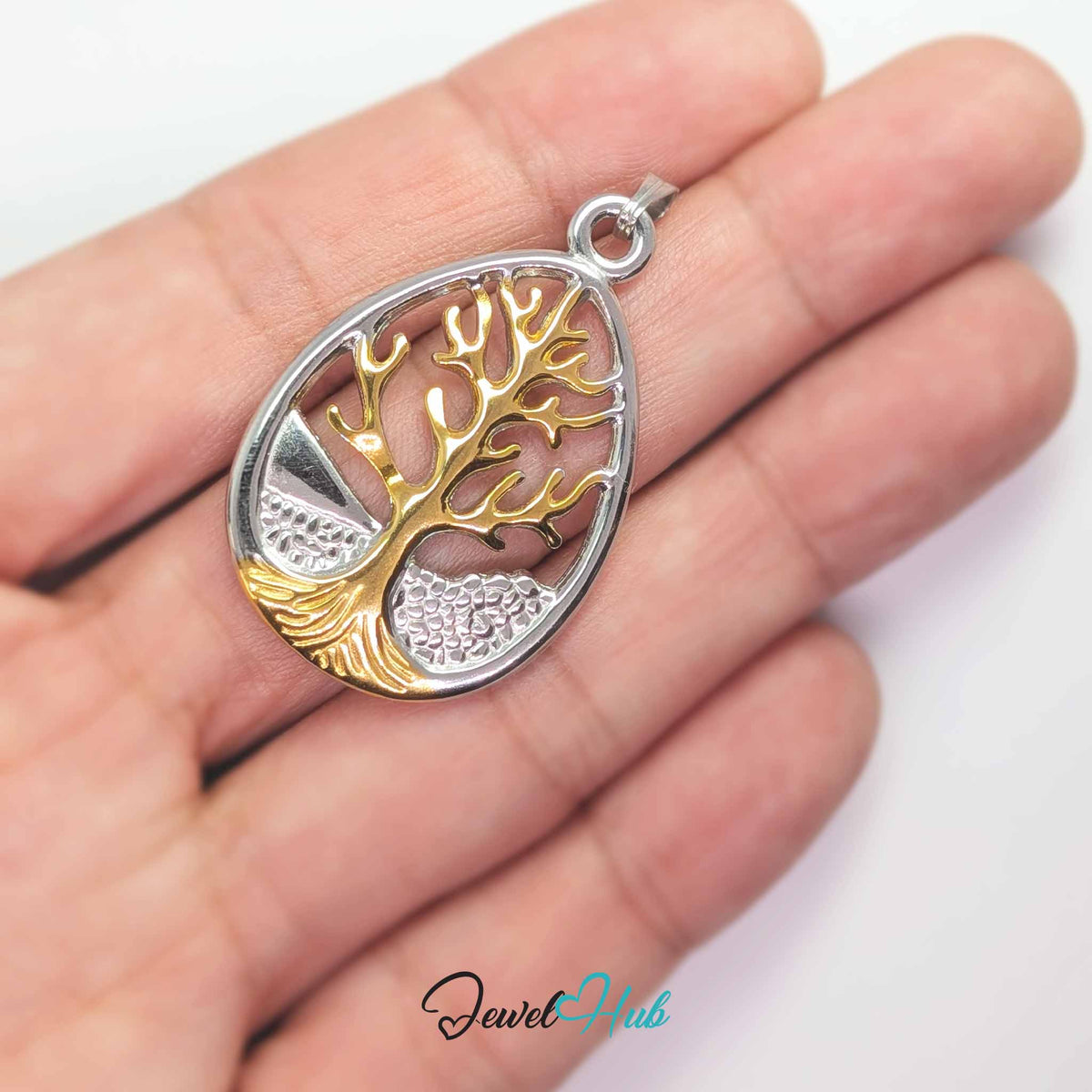 Tree of Life pendant in DuoTone stainless steel - held in the hand to show size - JewelHub