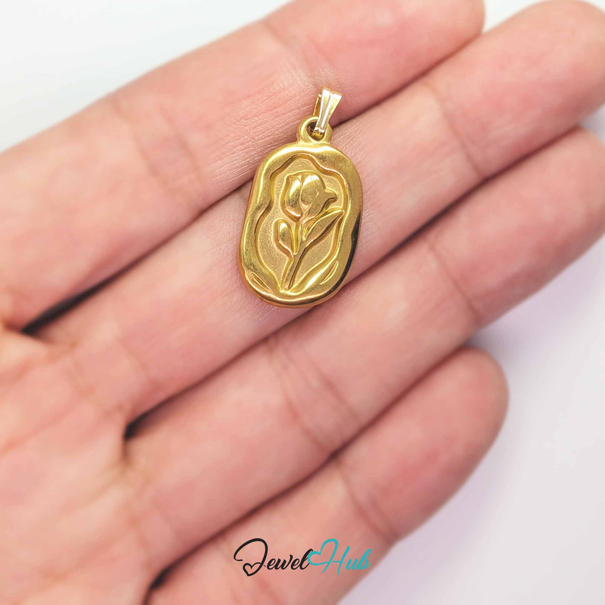 Gold Tulip Plate pendant in gold-tone stainless steel - held in the hand to show size - JewelHub