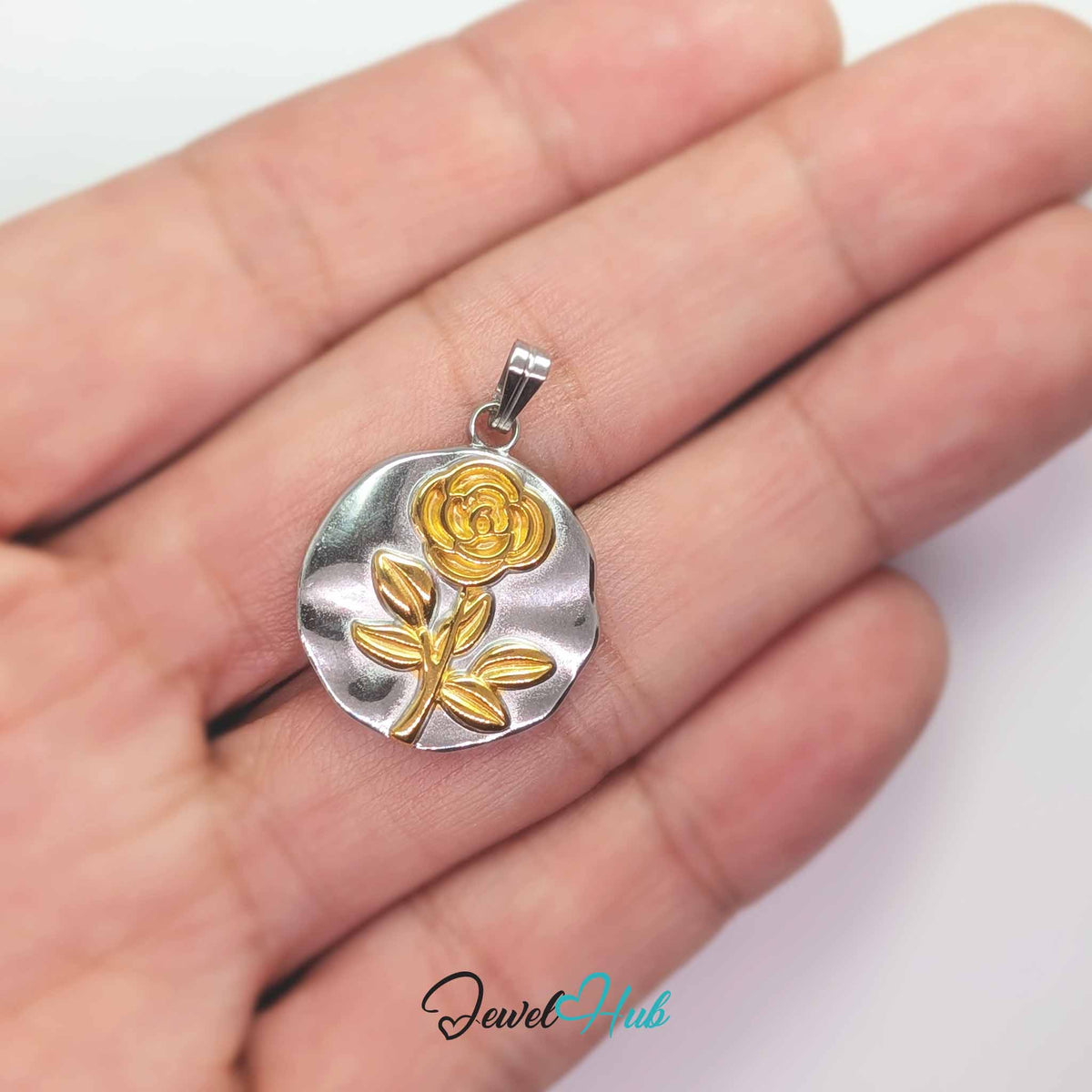 Rose Plate pendant in DuoTone stainless steel - held in the hand to show size - JewelHub