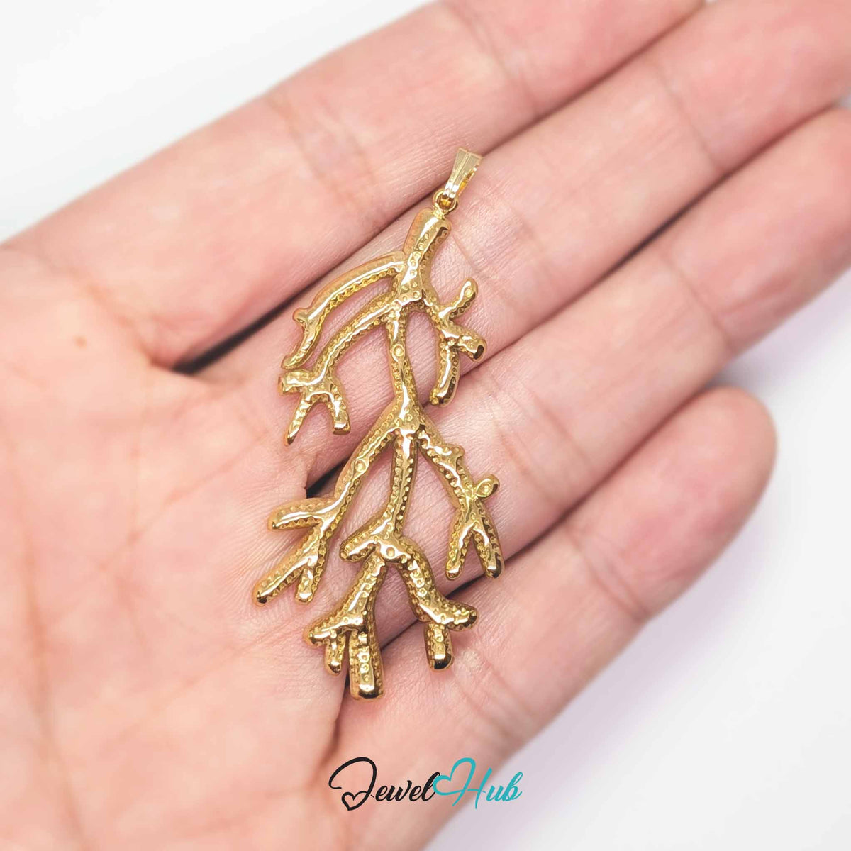Gold Coral Seaweed pendant in gold-tone stainless steel - held in the hand to show size - JewelHub