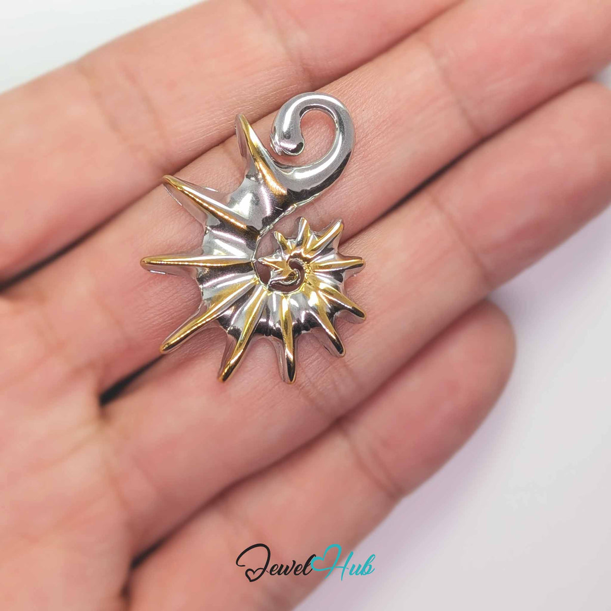 Spike Shell pendant in DuoTone stainless steel - held in the hand to show size - JewelHub