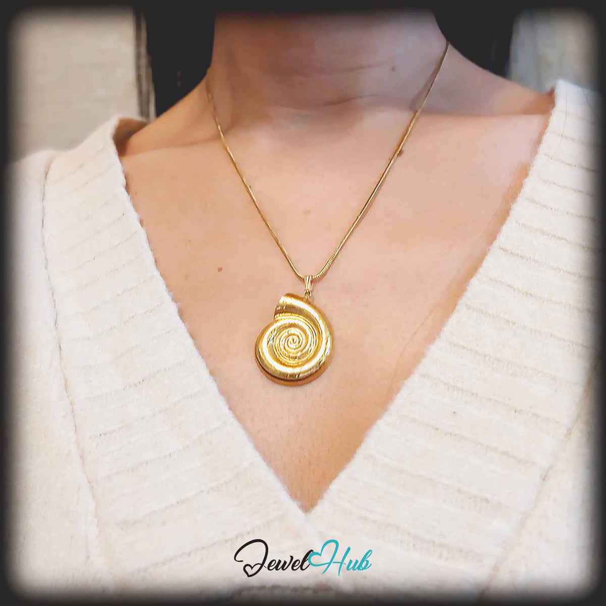 Gold Spiral Shell pendant in gold-tone stainless steel - worn on the neck - JewelHub