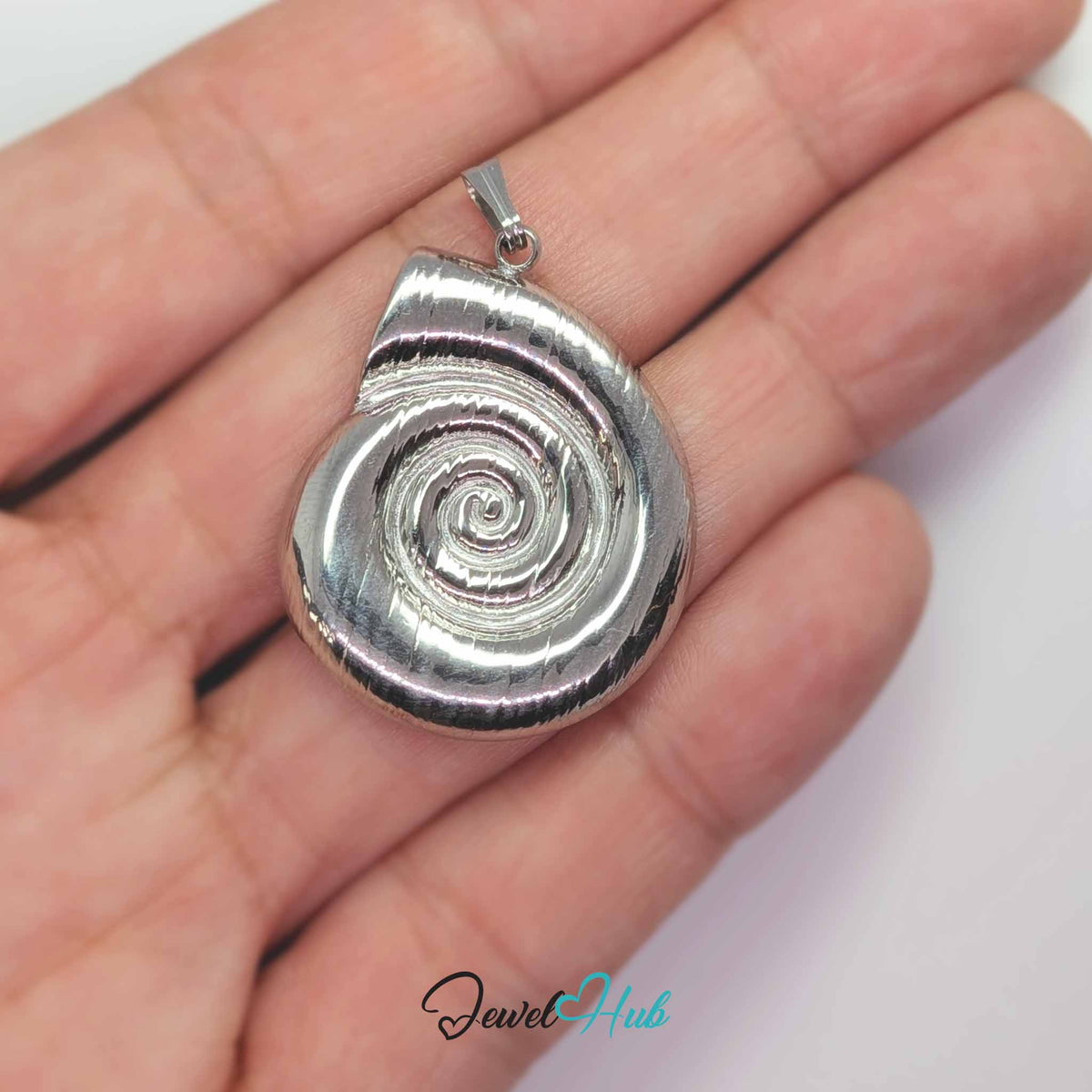 Silver Spiral Shell pendant in silver-tone stainless steel - held in the hand to show size - JewelHub