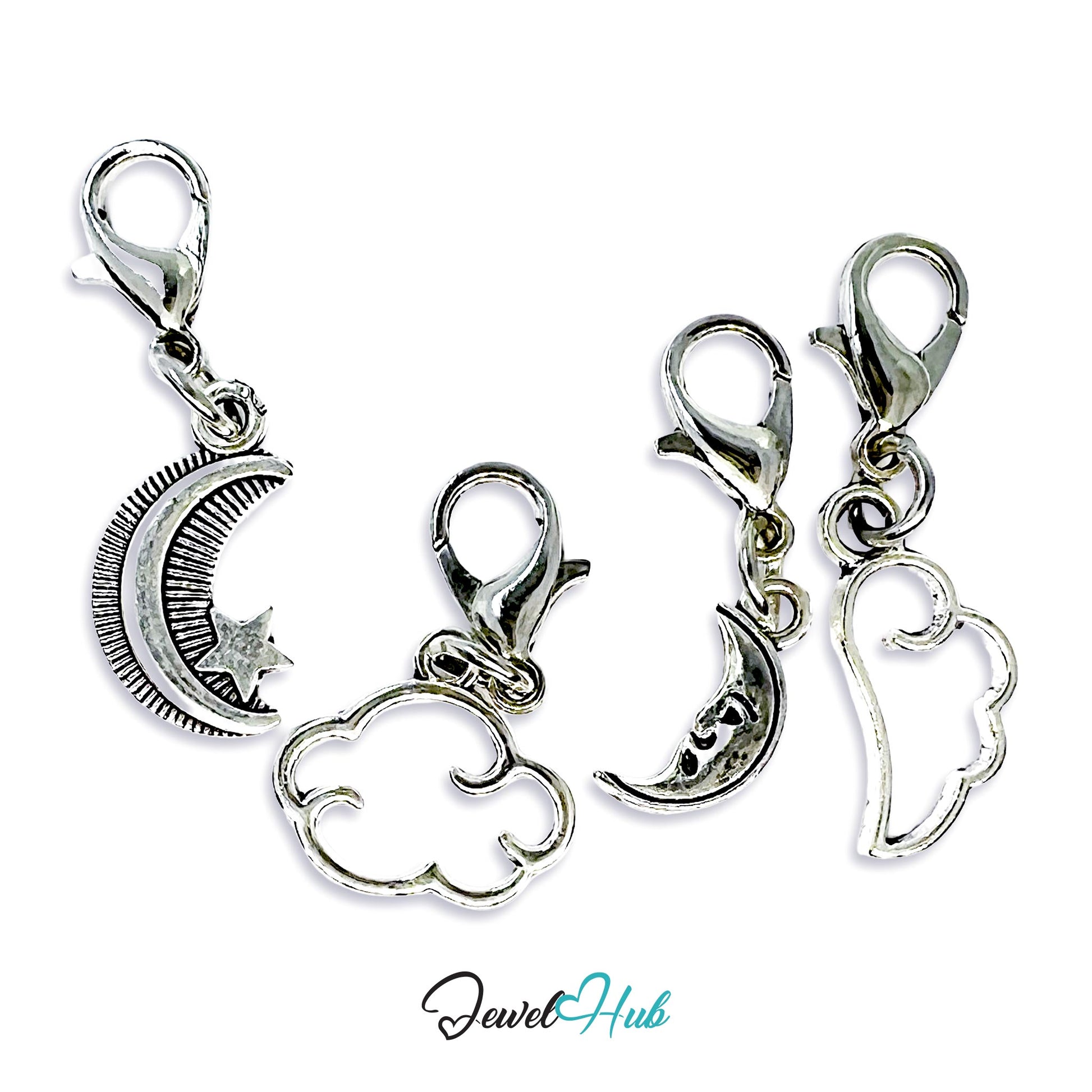Set of silver charms with moon, cloud, and angel design on a white background.