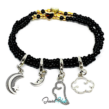Black beaded bracelet with silver charms on a white background