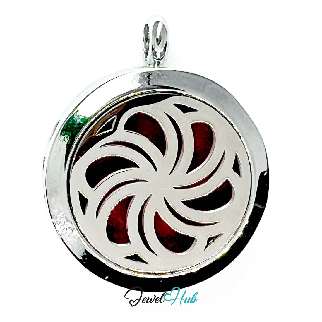 Silver locket with a red and green design on a white background