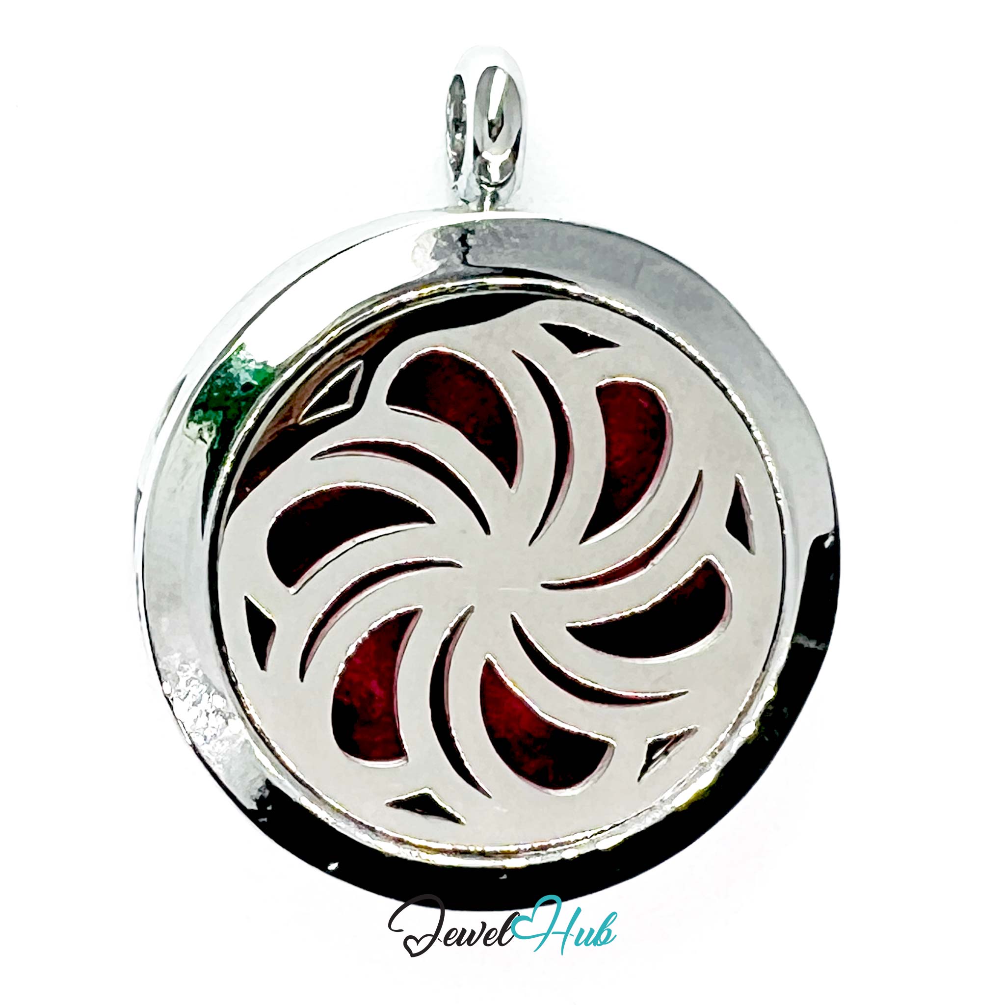 Silver locket with a red and green design on a white background