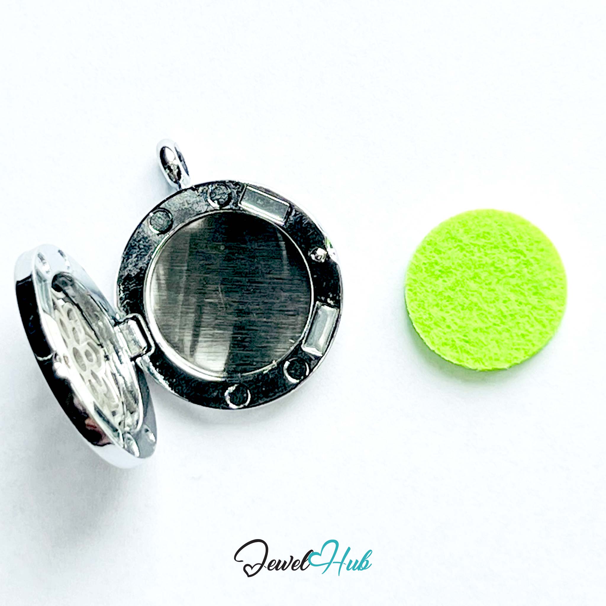 Silver locket with a green round object on a white background, branded 'Jewel Hub'.