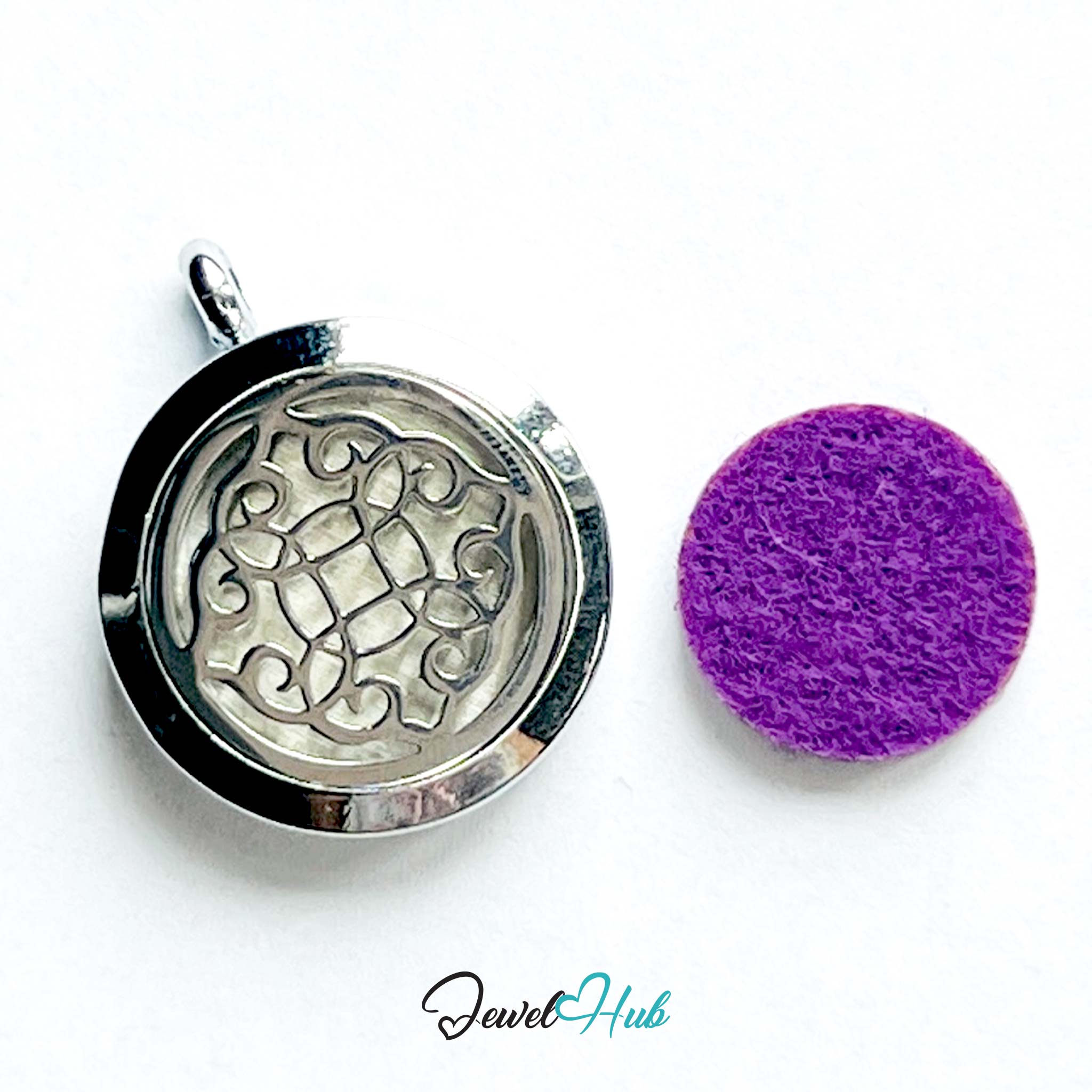 Silver pendant with intricate design and purple felt pad on a white background, branded 'Jewel Hub'.