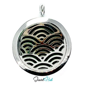 Round silver pendant with wave pattern on a white background, branded 'Jewel Hub'.