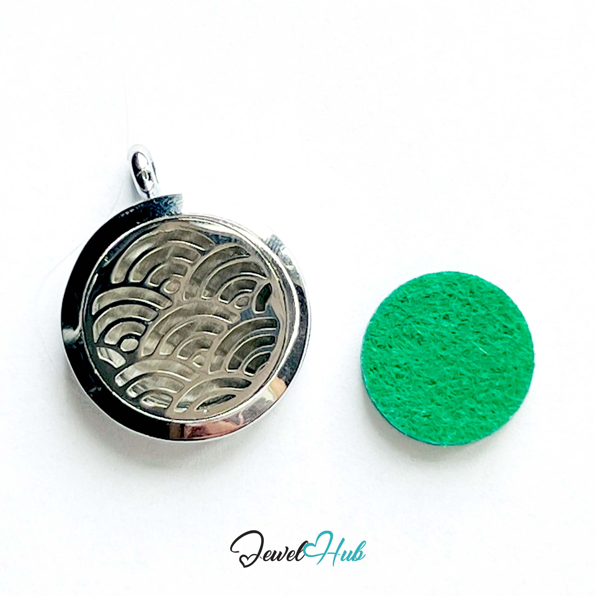 Silver locket with wave design and green cleaning cloth on a white background, branded 'Jewel Hub'.