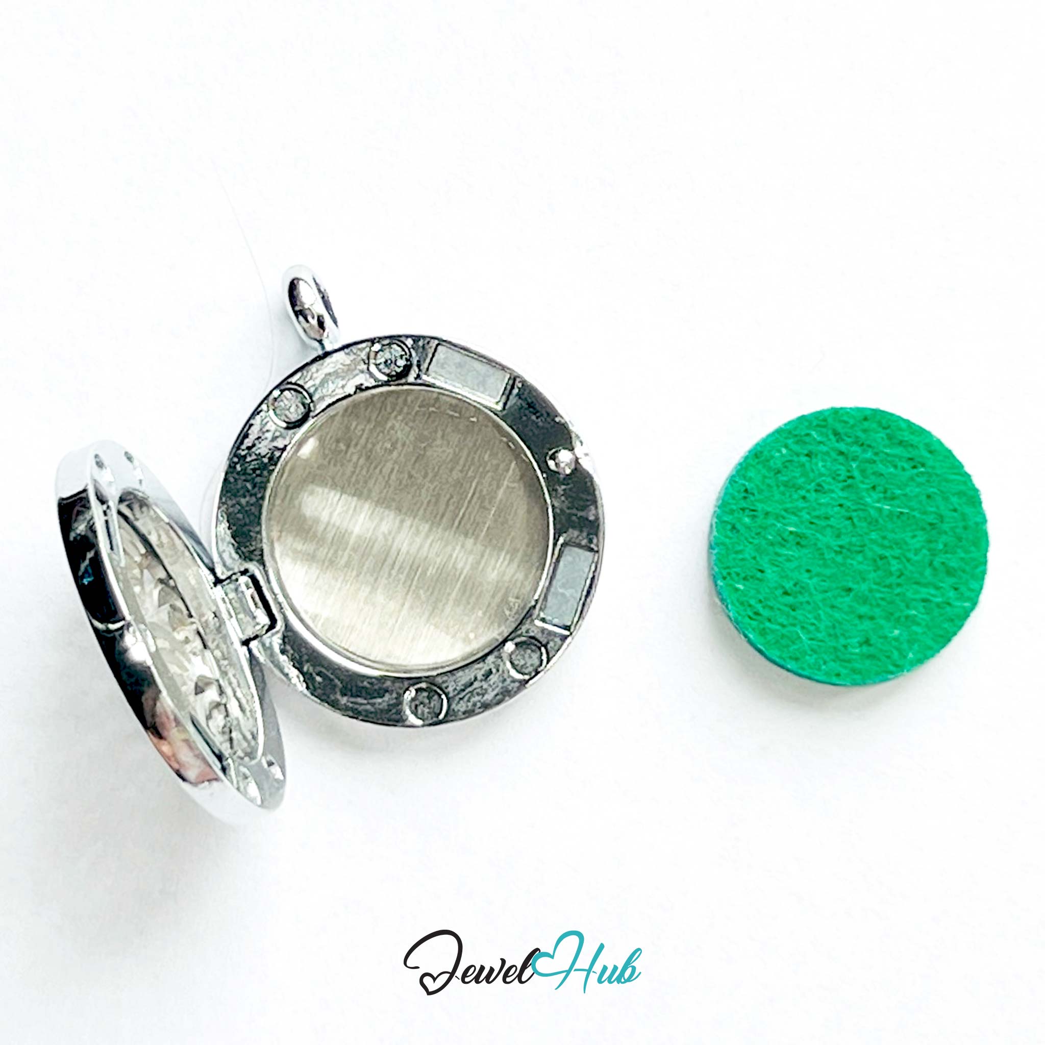 Silver locket with a green felt pad on a white background, branded 'Jewel Hub'.