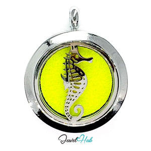 Round pendant with seahorse design on a yellow background, branded 'Jewel Hub'.