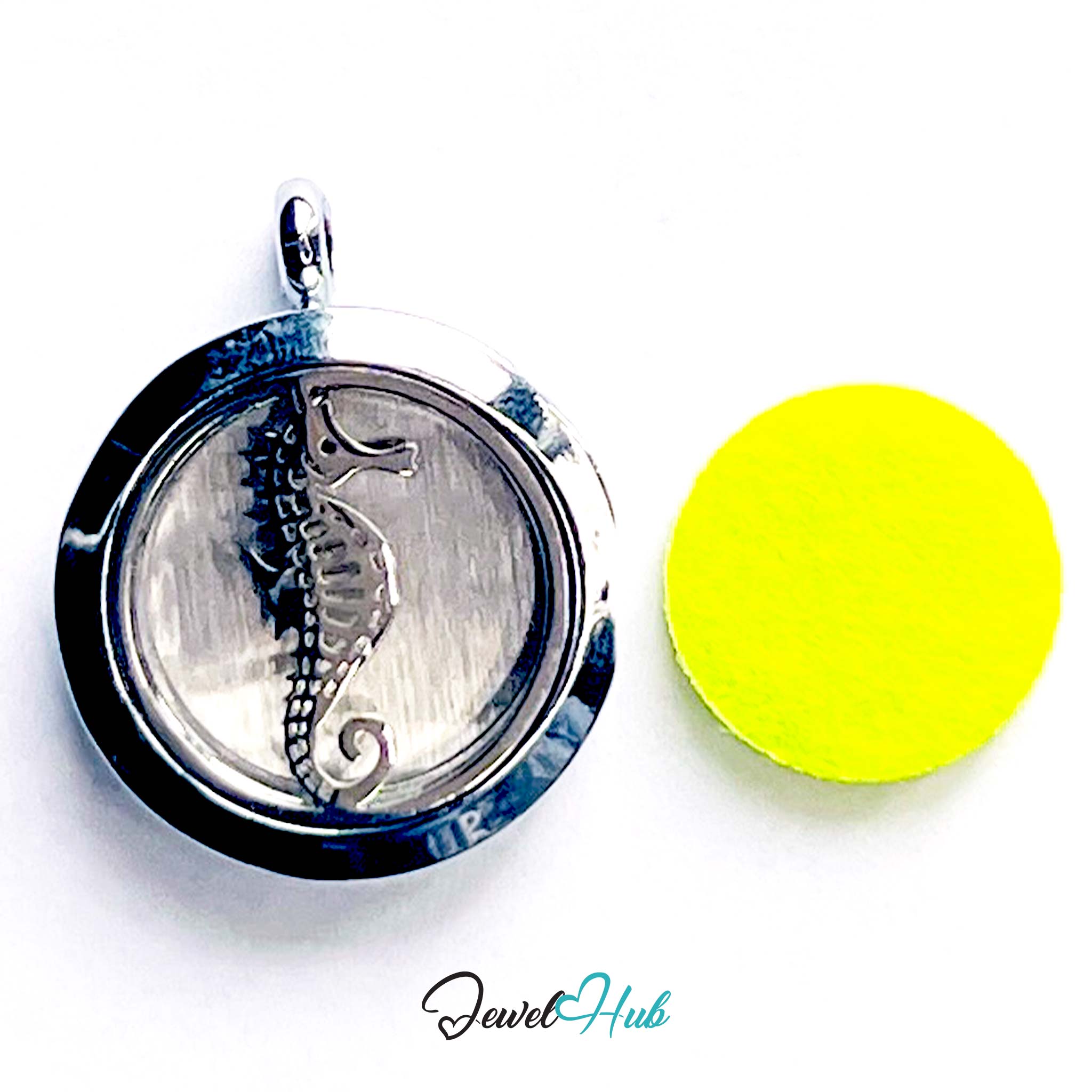 Silver seahorse pendant in a locket with a yellow disc on a white background, branded 'Jewel Hub'.