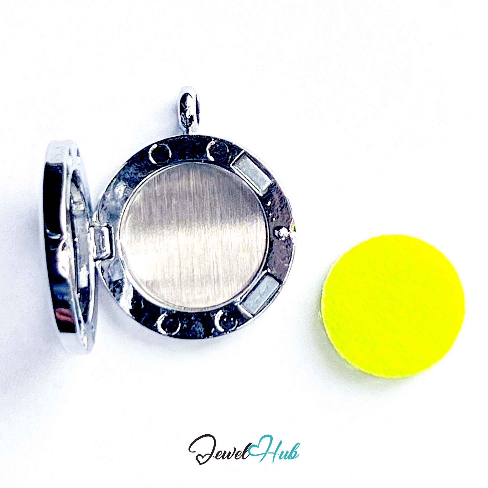 Silver locket with a yellow disc on a white background, branded 'Jewel Hub'.