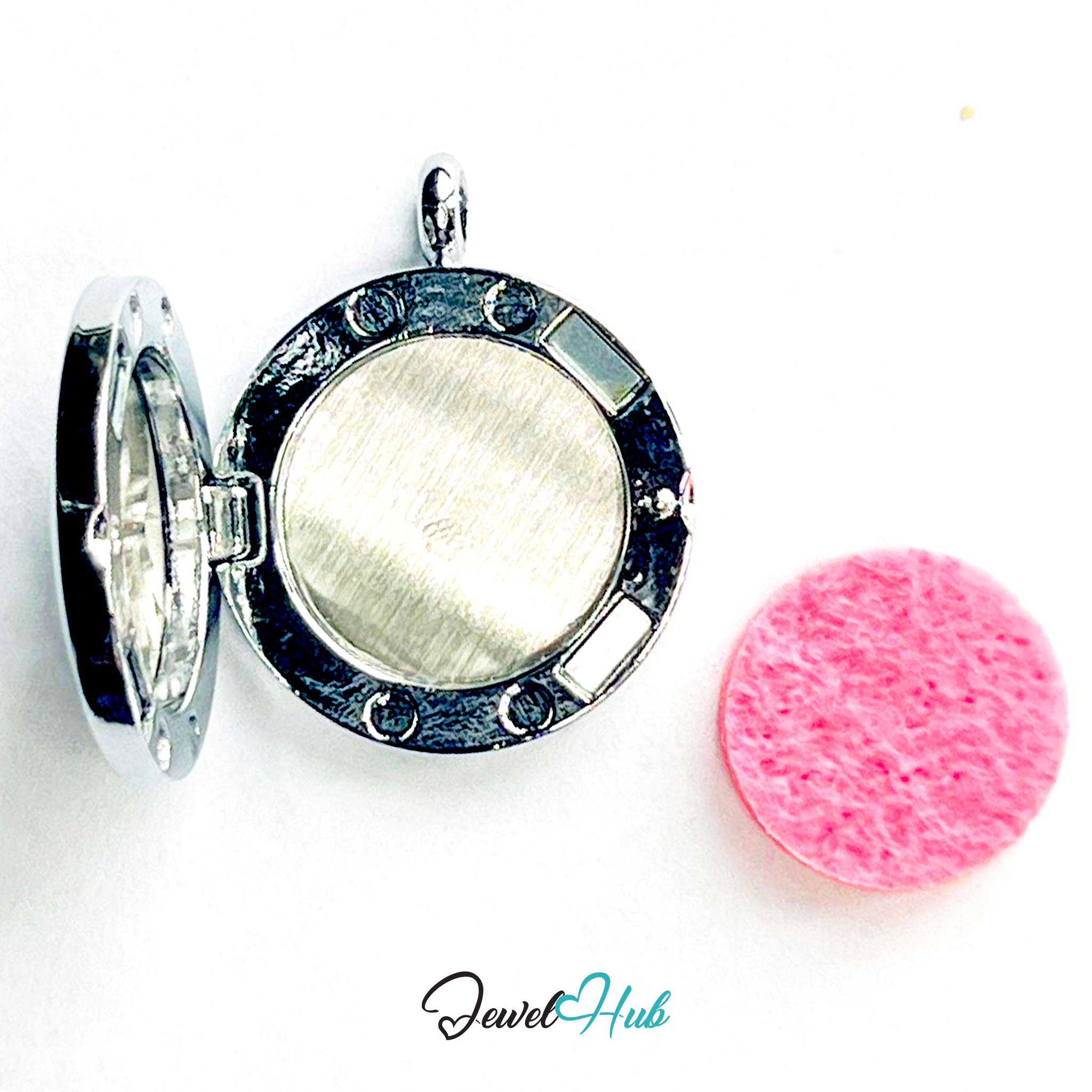 Round silver locket with a pink cleaning cloth on a white background, branded 'Jewel Hub'.