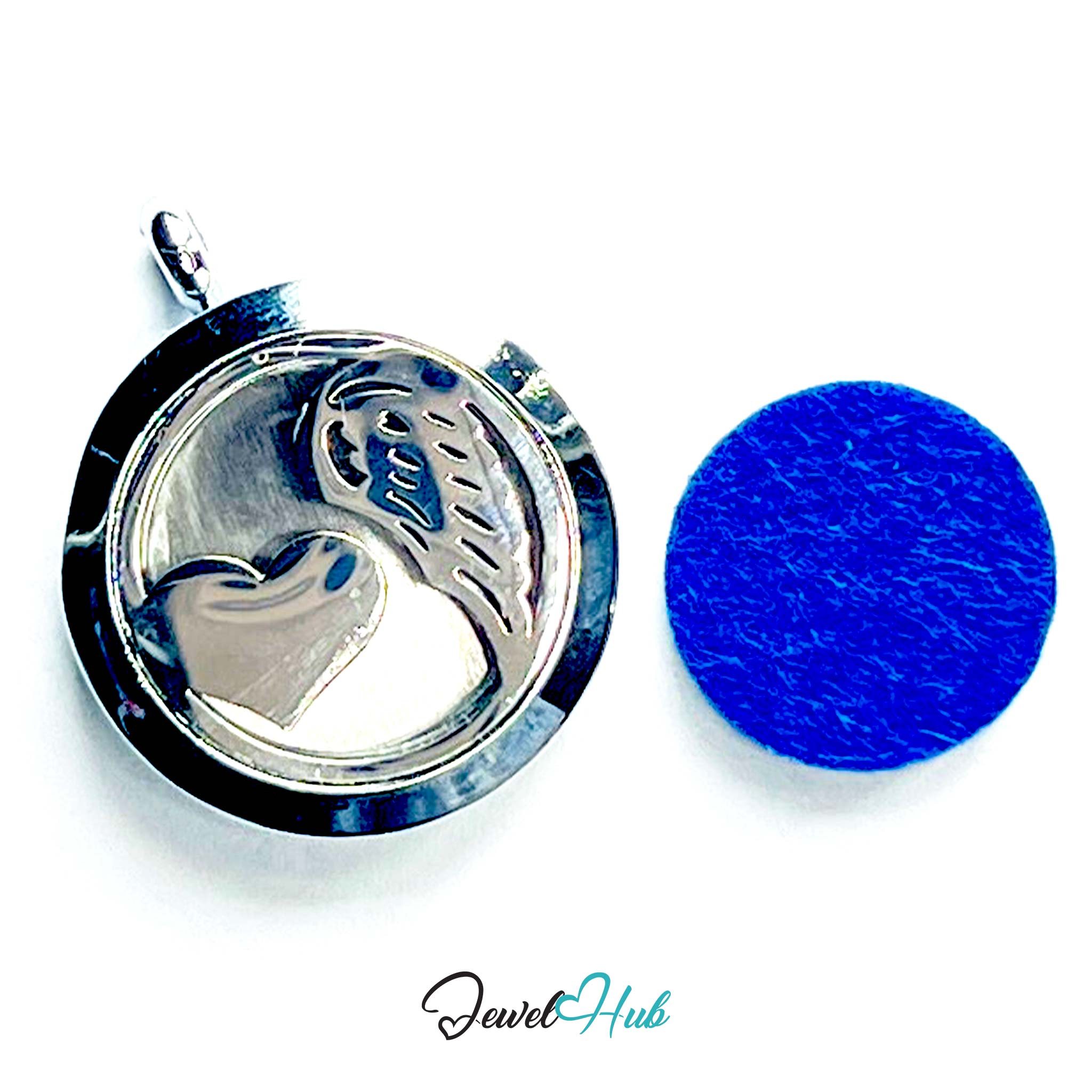 Silver pendant with heart design on a white background, next to a blue round object.