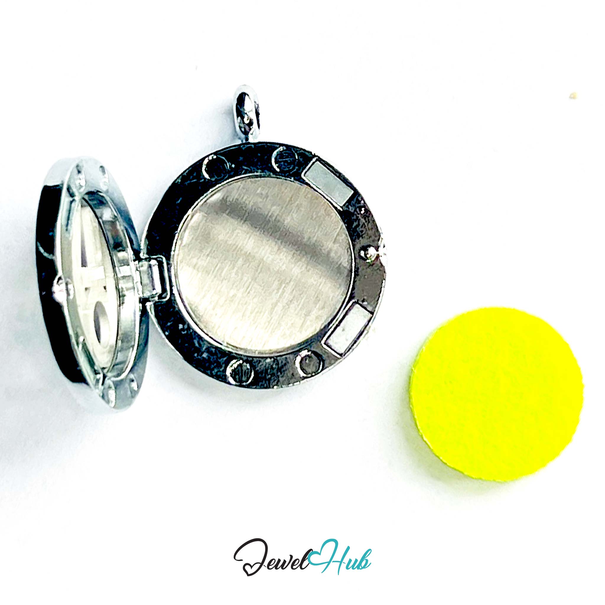 Silver locket with a yellow disc on a white background, branded 'Jewel Hub'.