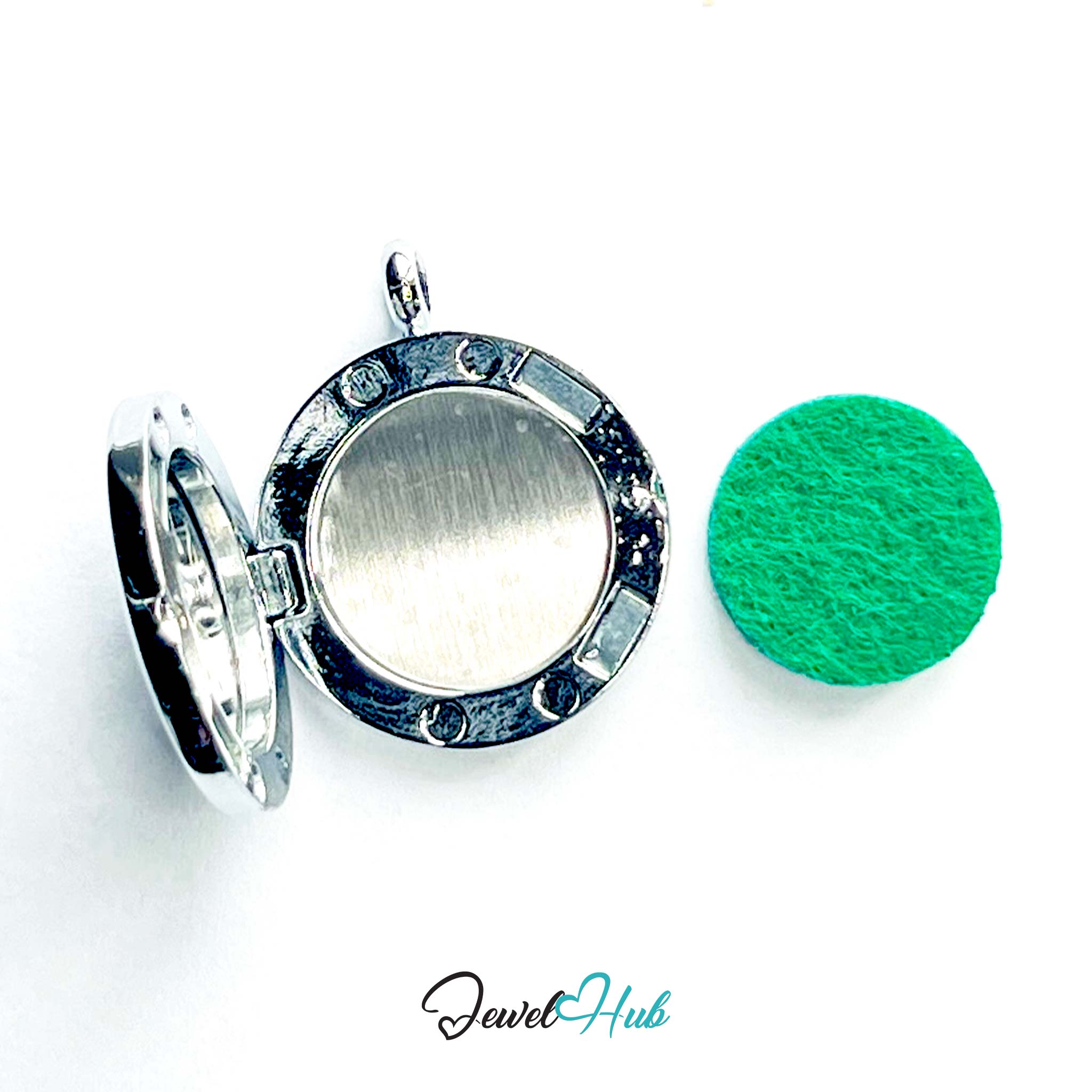 Silver locket and green round object on a white background with 'Jewel Hub' branding.