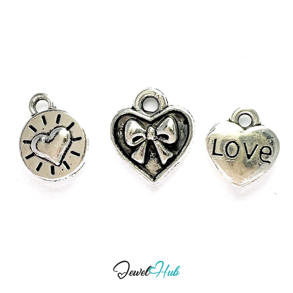 Three silver heart-shaped charms with different designs on a white background, branded 'Jewel Hub'.