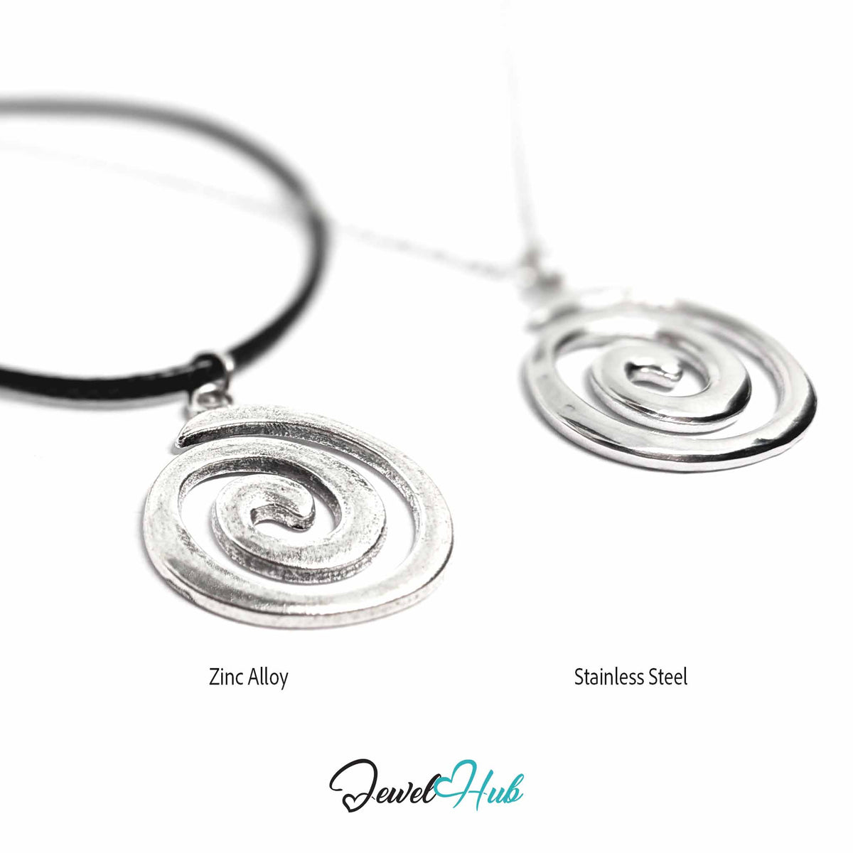 Two spiral pendant necklaces on a white background, labeled 'Zinc Alloy' and 'Stainless Steel,' with the JewelryHub logo below. One pendant is silver-toned with a black cord, and the other is silver-toned with a thin chain.