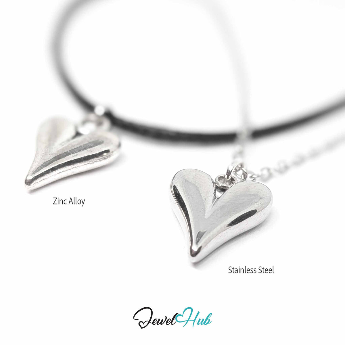 Close-up of zinc alloy and stainless steel heart pendants on black cord and silver chain, blurred background - JewelHub