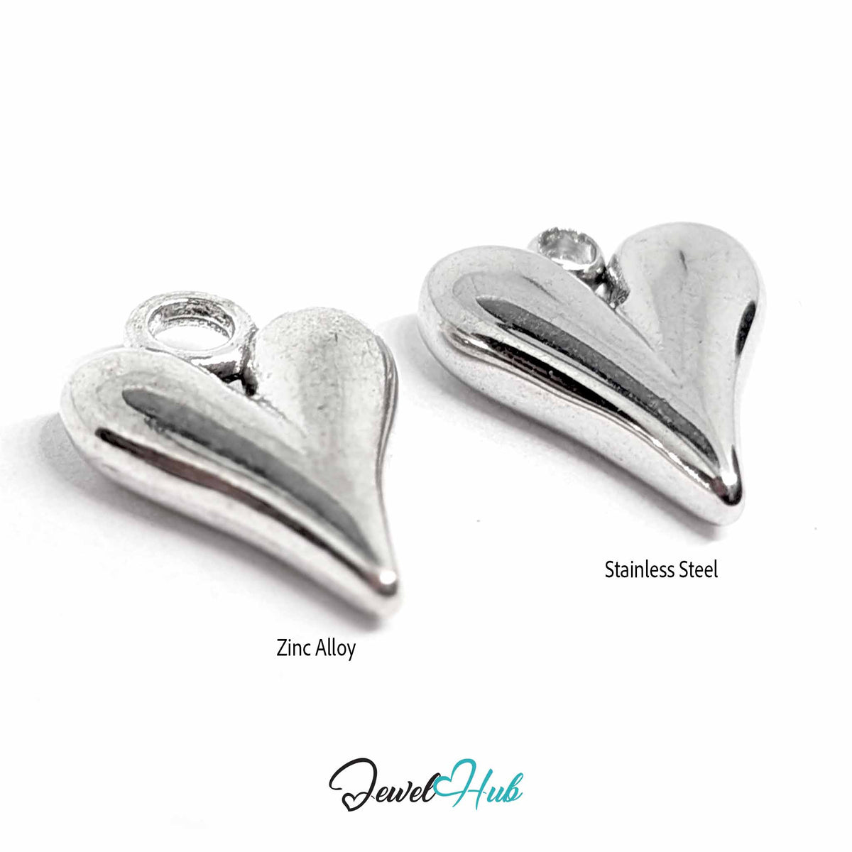 Zinc alloy and stainless steel heart pendants from a three-quarter angle, showing curved surface and jump rings - JewelHub
