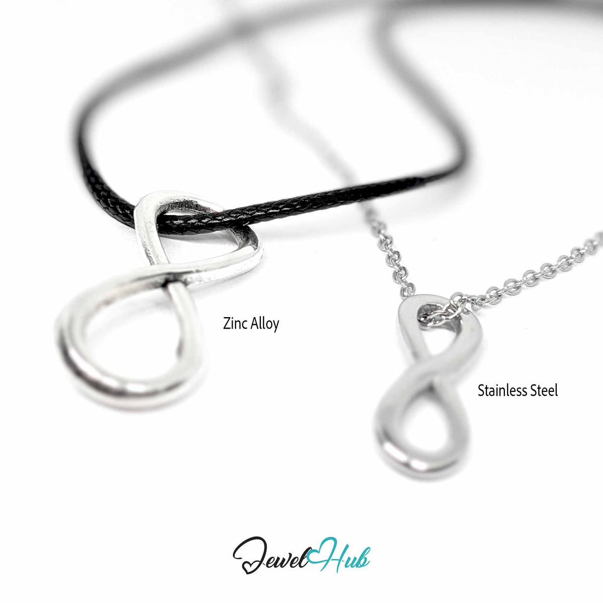 Close-up of zinc alloy and stainless steel infinity pendants on black cord and silver chain, blurred background - JewelHub