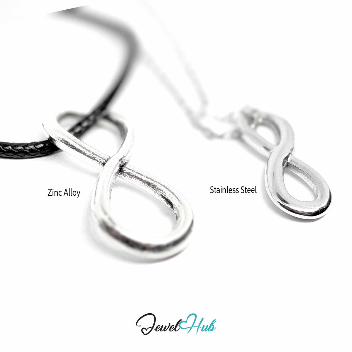 Angled view of zinc alloy infinity pendant on cord and stainless steel infinity pendant on chain, soft focus - JewelHub