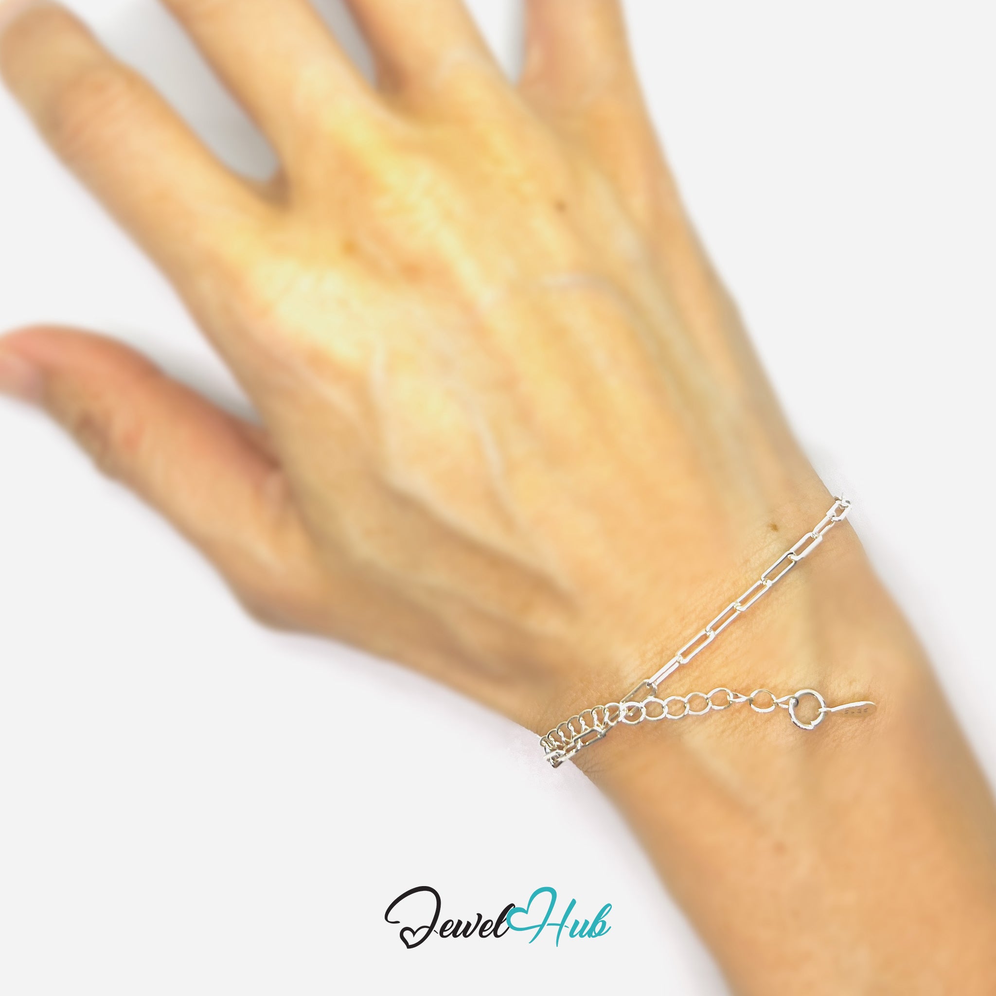 Silver bracelet on a wrist with 'Jewel Hub' branding.