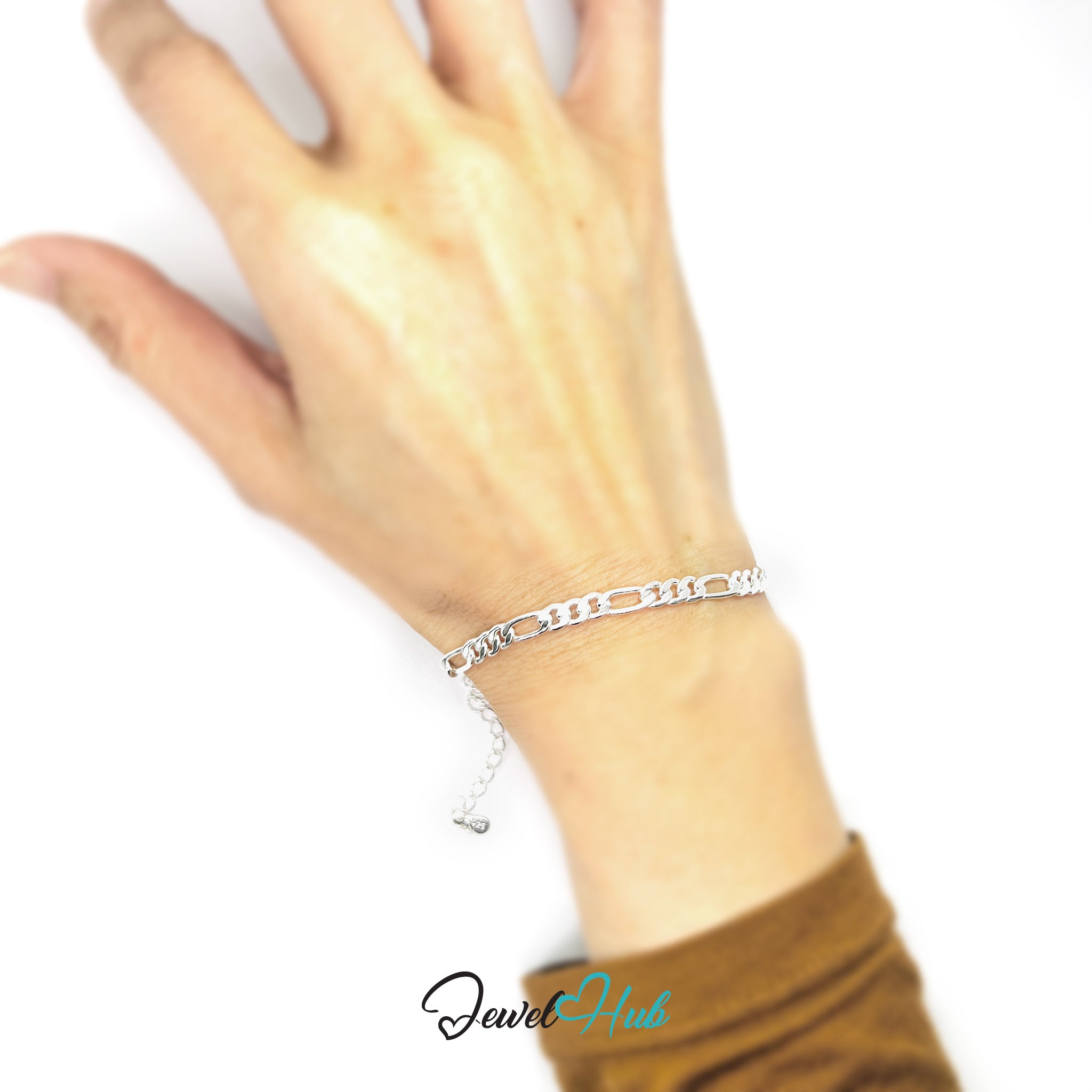 Silver bracelet on a wrist with a blurred background, featuring the brand 'Jewel Hub'.