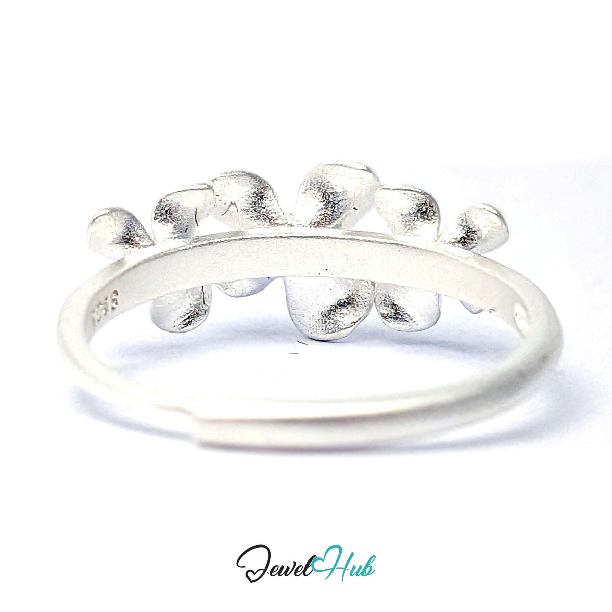 Three Flower Ring seen from above, showing the brushed petals and the open back of the band