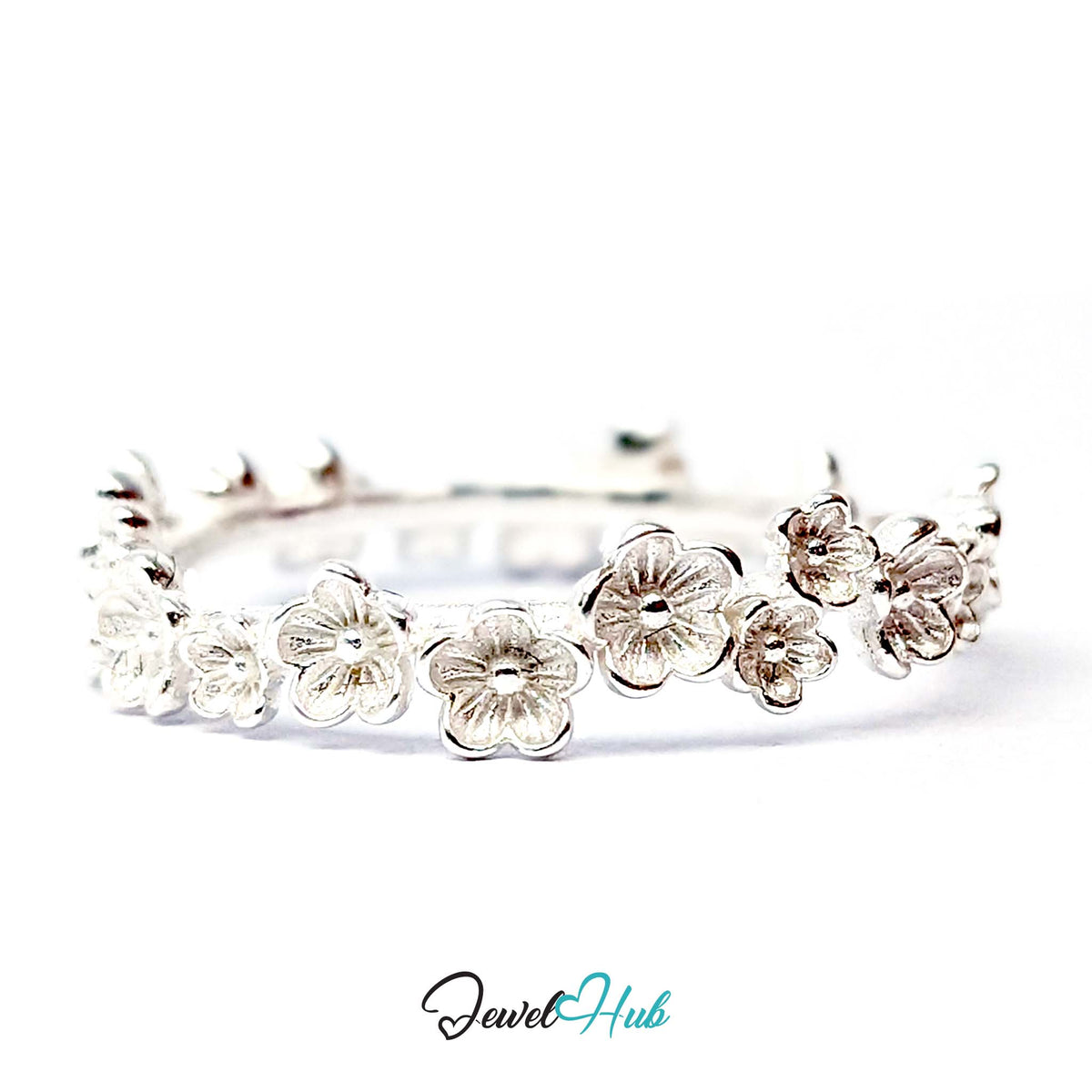 Blossom Band Ring at an angle, showing blossoms running the full width of the band