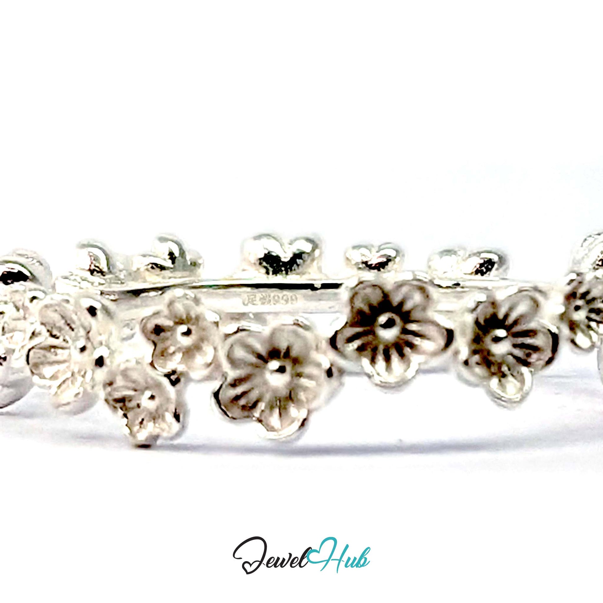 Close view of the blossom row with the inside of the 999 fine silver band visible