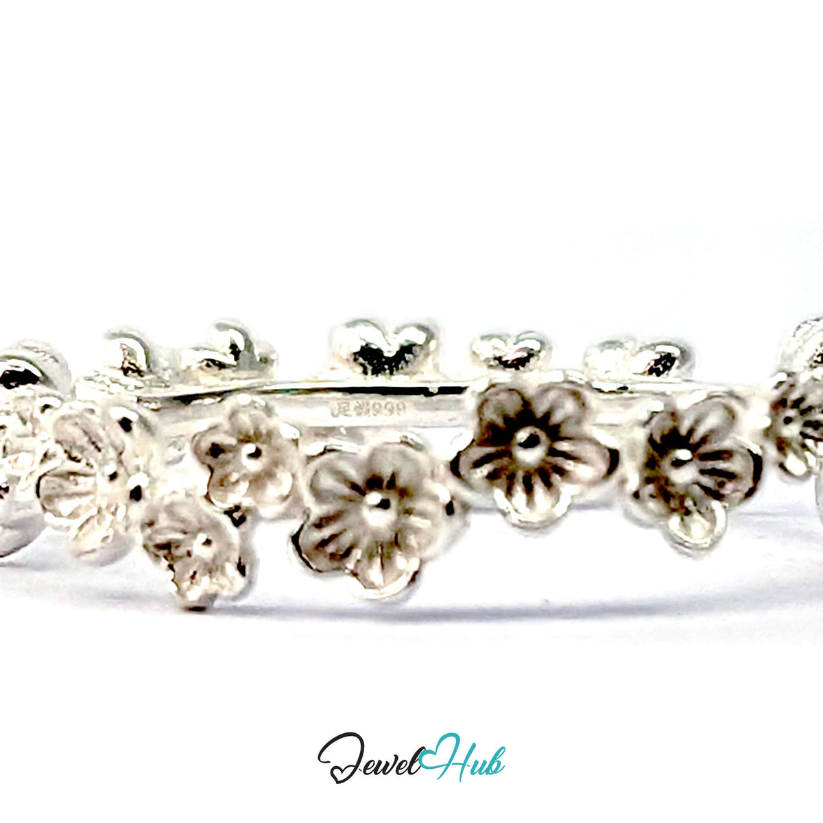 Close view of the blossom row with the inside of the 999 fine silver band visible