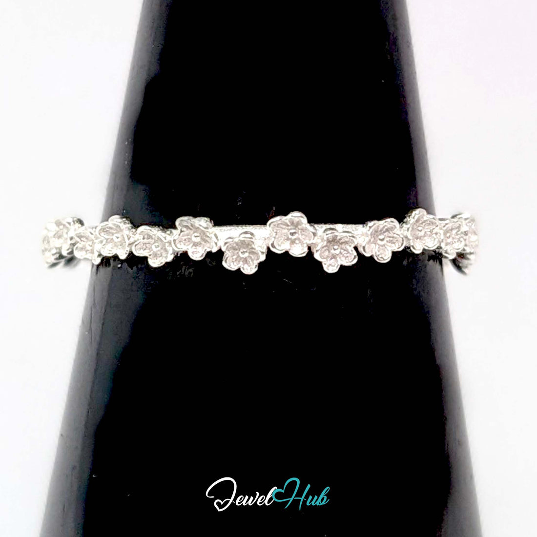 Mini Blossom Band Ring in 999 fine silver, a 2.5mm band of tiny five-petal flowers, front view