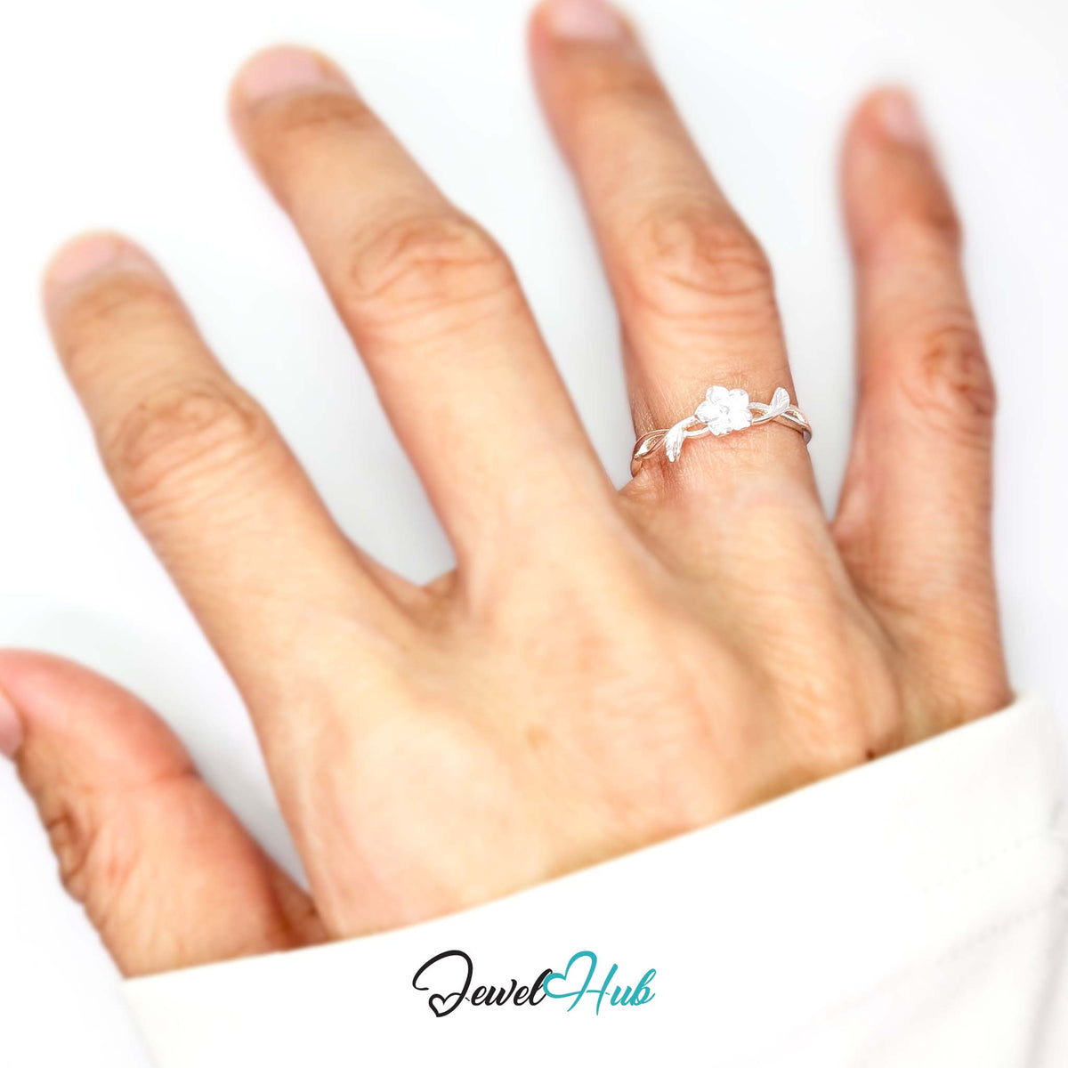 Peach Blossom Vine Ring worn on a hand, showing the fit of the adjustable M-O band