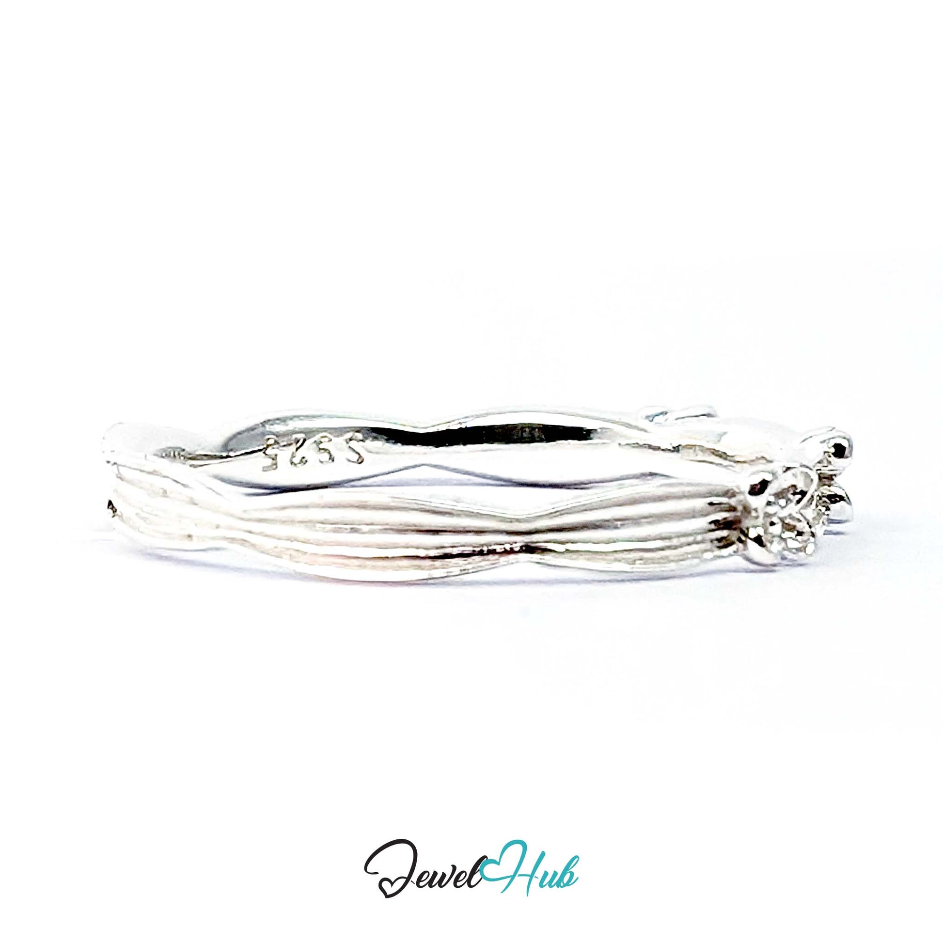 Close view of the small flowers set into the ribbed silver band