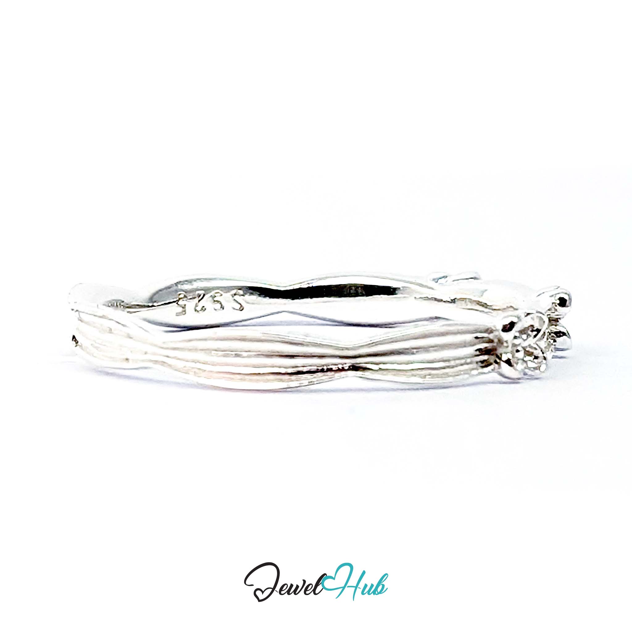 Close view of the small flowers set into the ribbed silver band
