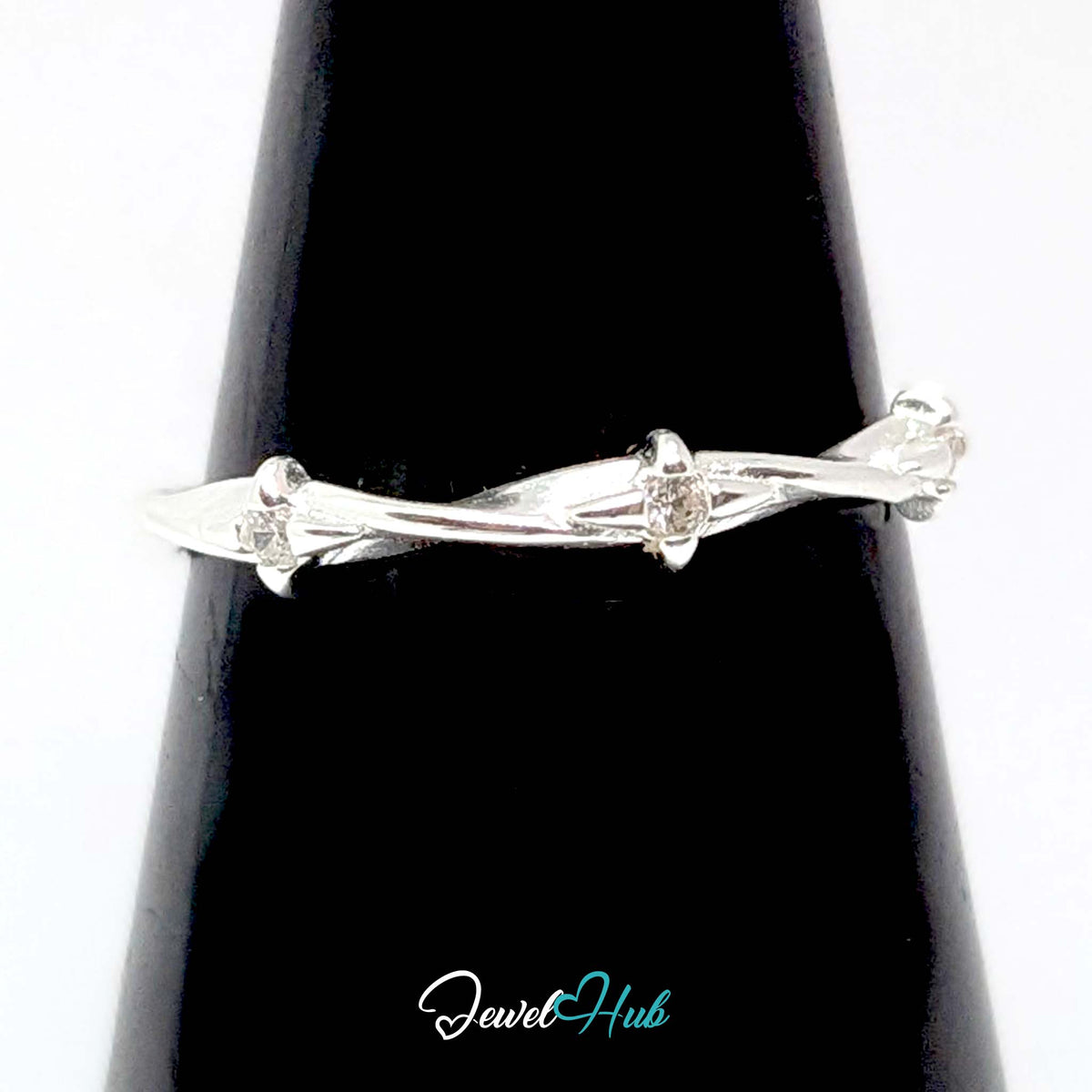 Three Spark Ring against a black cone, showing the spaced zirconia sparkle