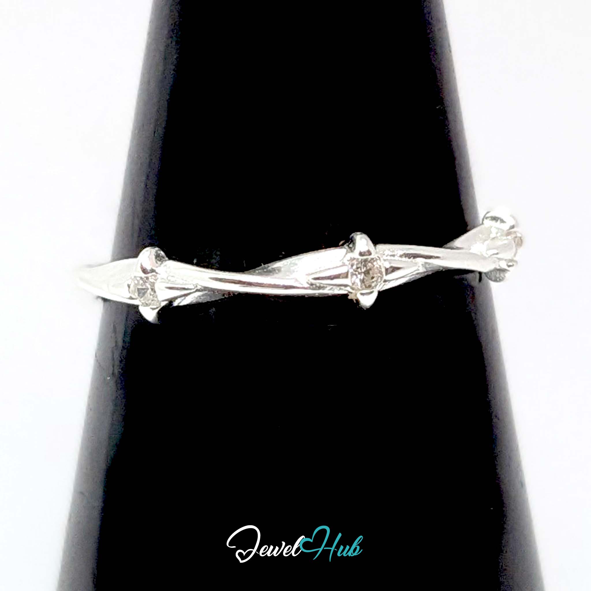 Three Spark Ring against a black cone, showing the spaced zirconia sparkle