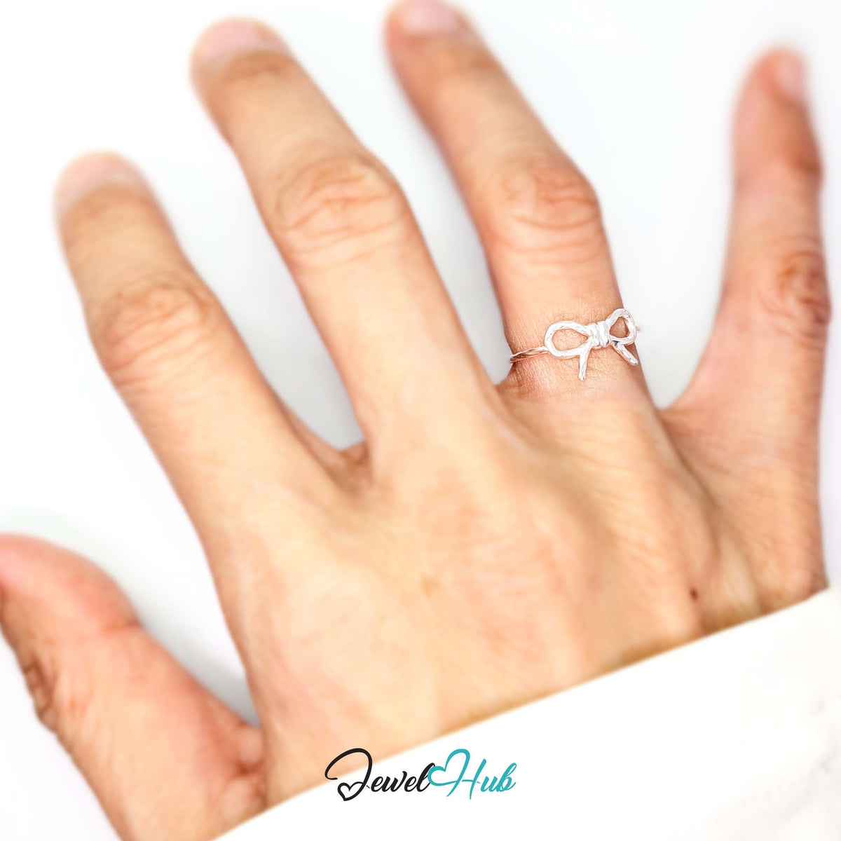 Bow Ring worn on a hand, showing the fit of the adjustable J band