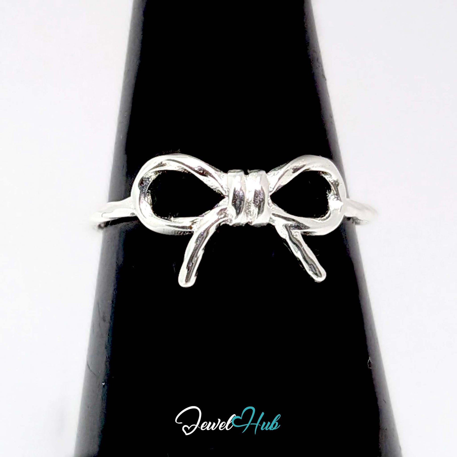 Bow Ring against a black cone, showing the tied bow shape