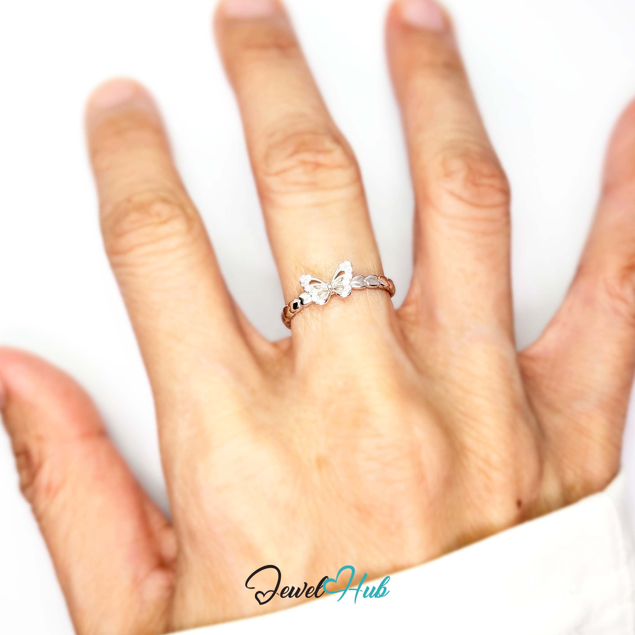Butterfly Ring worn on a hand, showing the fit of the adjustable M-O band