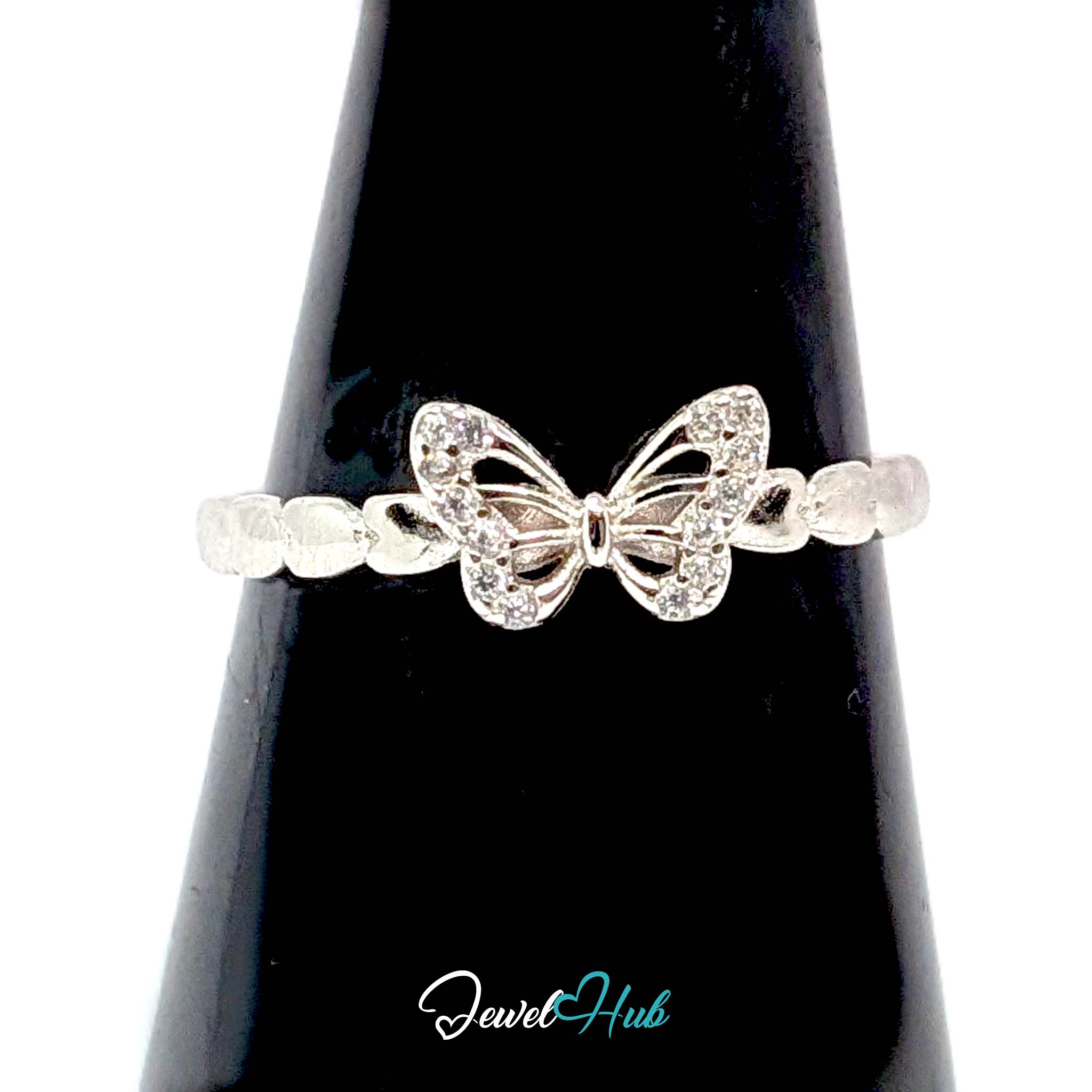 Butterfly Ring against a black cone, showing the twelve zirconia on the wings