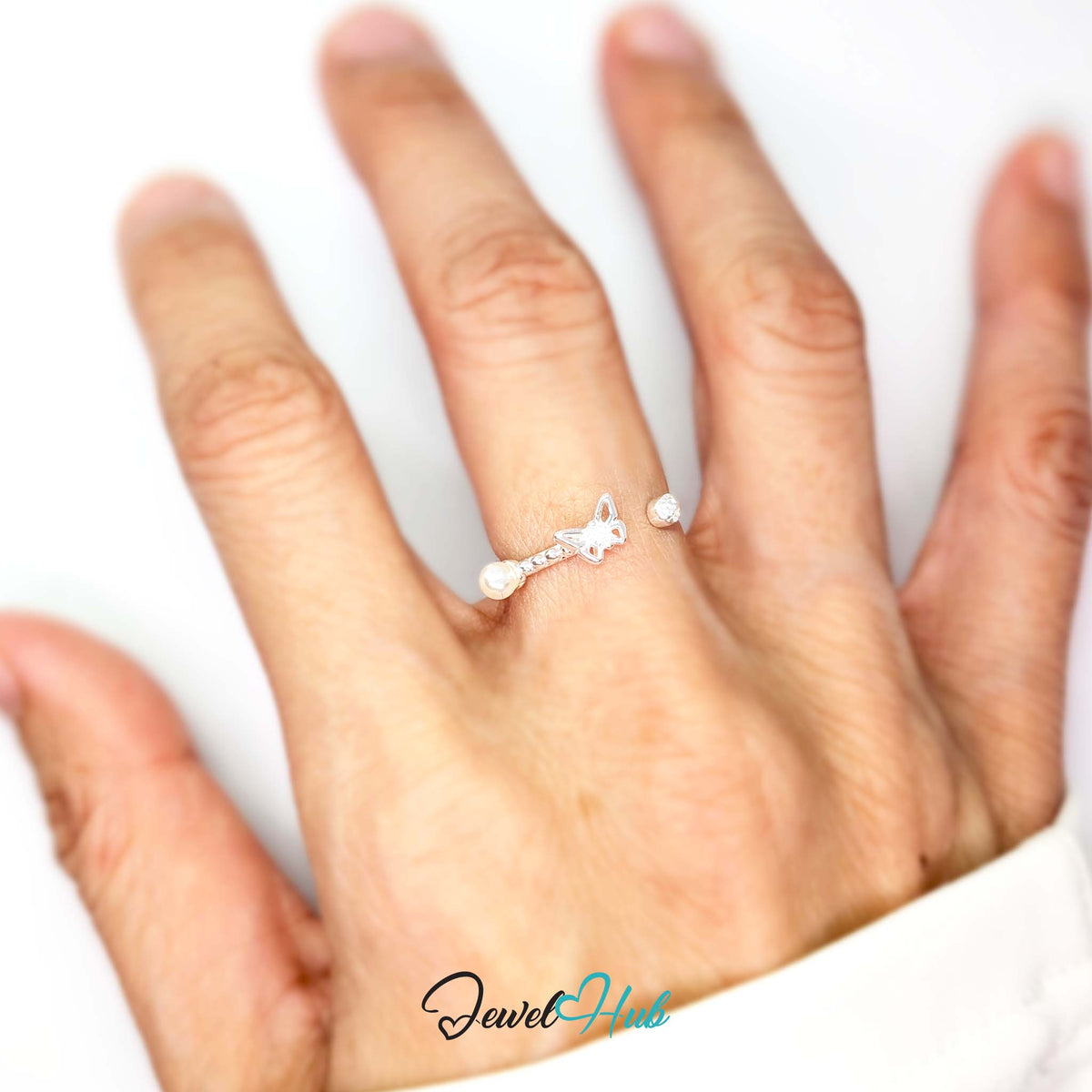 Butterfly ring worn on a hand, showing the fit of the adjustable M-O band - JewelHub