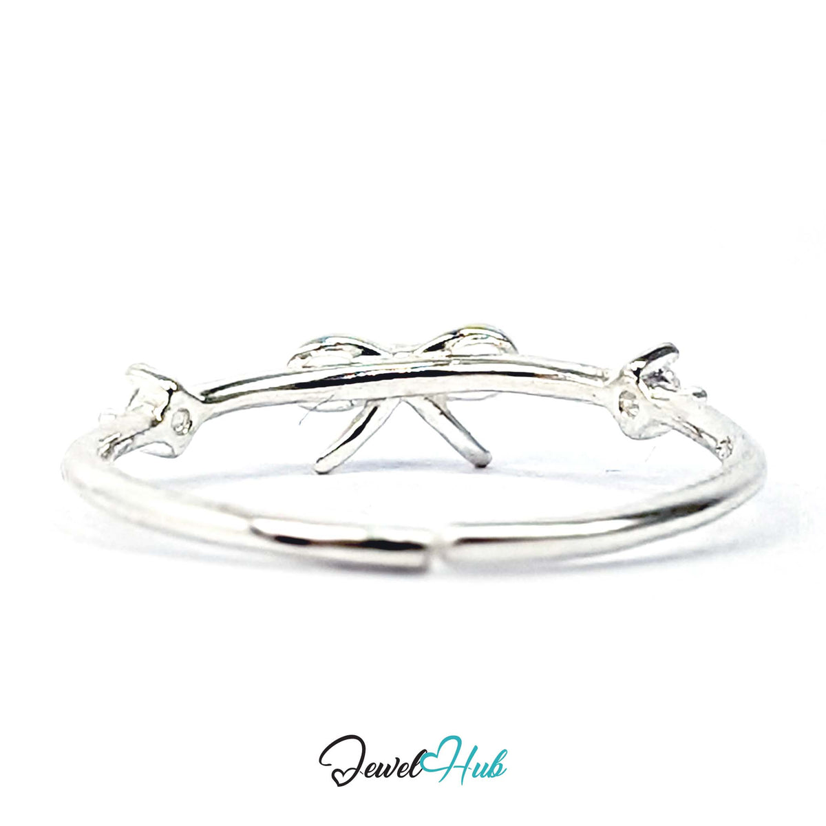 Open bow ring from above, with light passing through the outlined loops - JewelHub