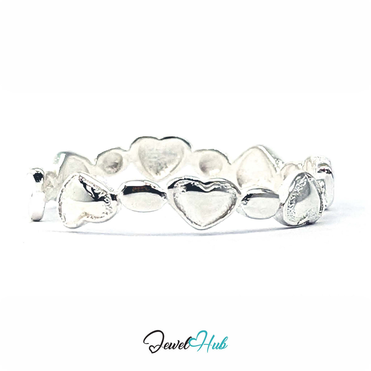 Heart band ring at an angle, the polished heart faces catching the light - JewelHub