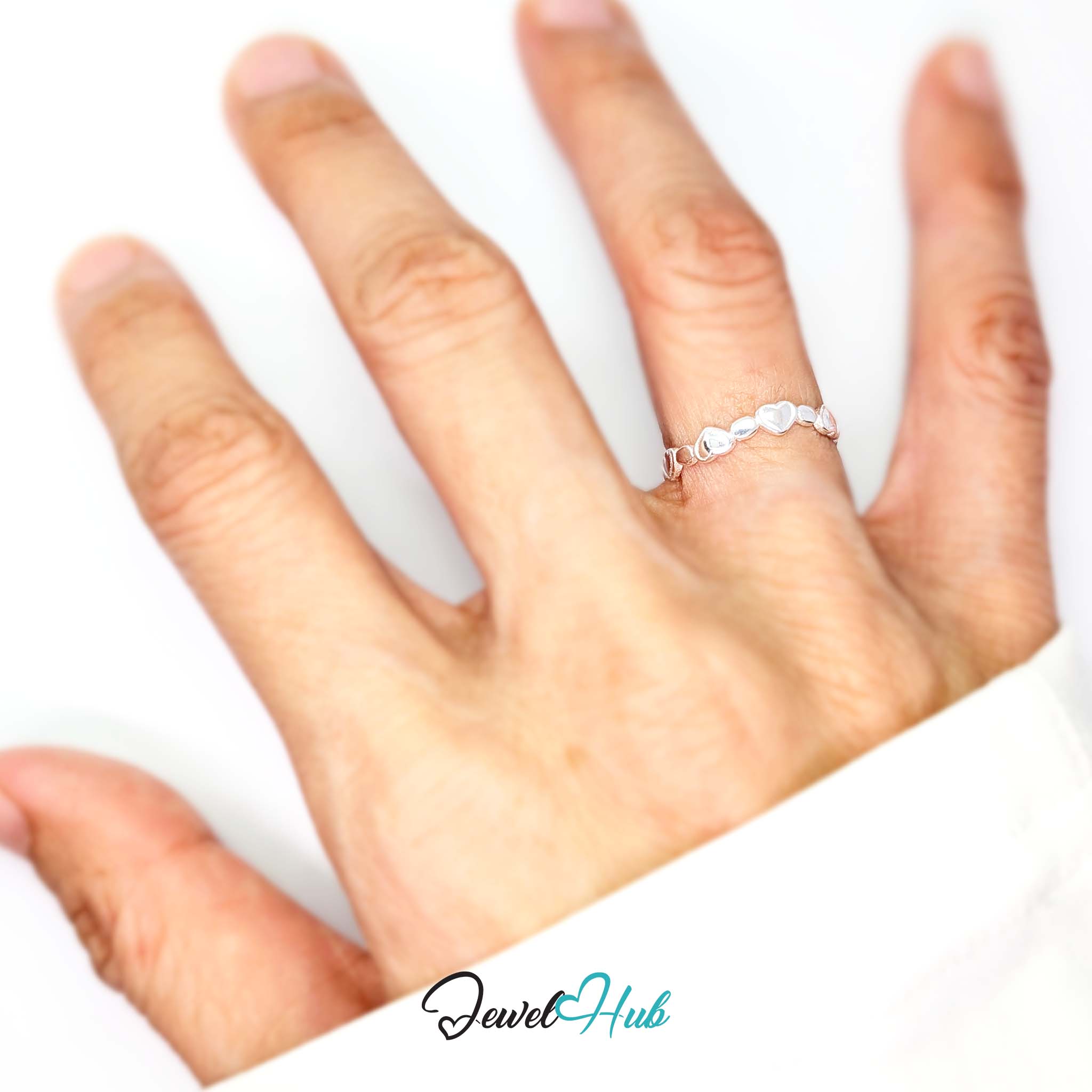 Heart band ring worn on a hand, showing the fit of the adjustable M-O band - JewelHub